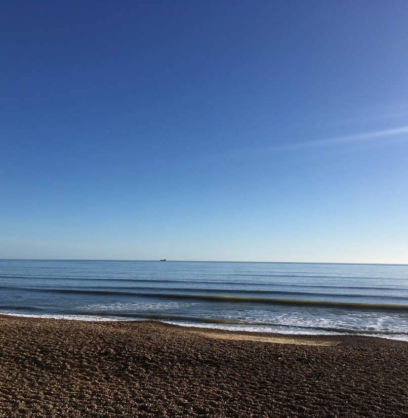 View of the Sea from Bowleaze Cove Beach on a Sunny Blue Day