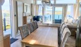 Internal of a caravan open plan living space with seaviews