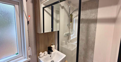 Internal of a caravan bathroom with shower and sink