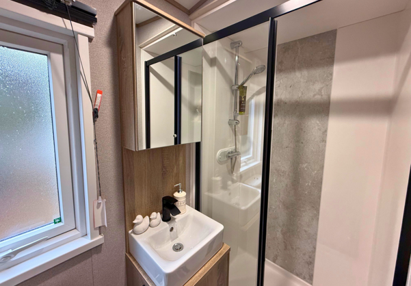 Internal of a caravan bathroom with shower and sink