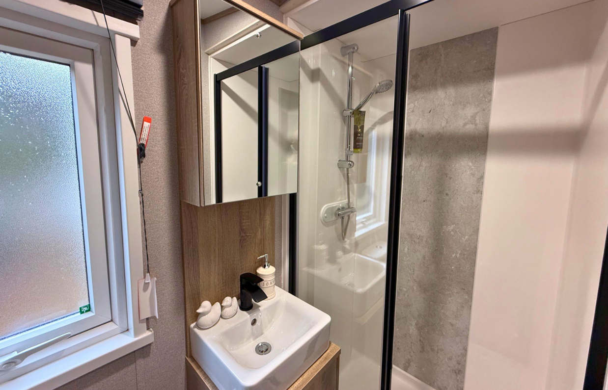 Internal of a caravan bathroom with shower and sink