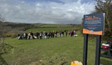 A group of people with dogs in a dog agility field for a Trufts Dog Show at Tregoad Holiday Park