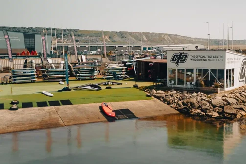 A watersports centre at the water's edge with a range of watersports equipment