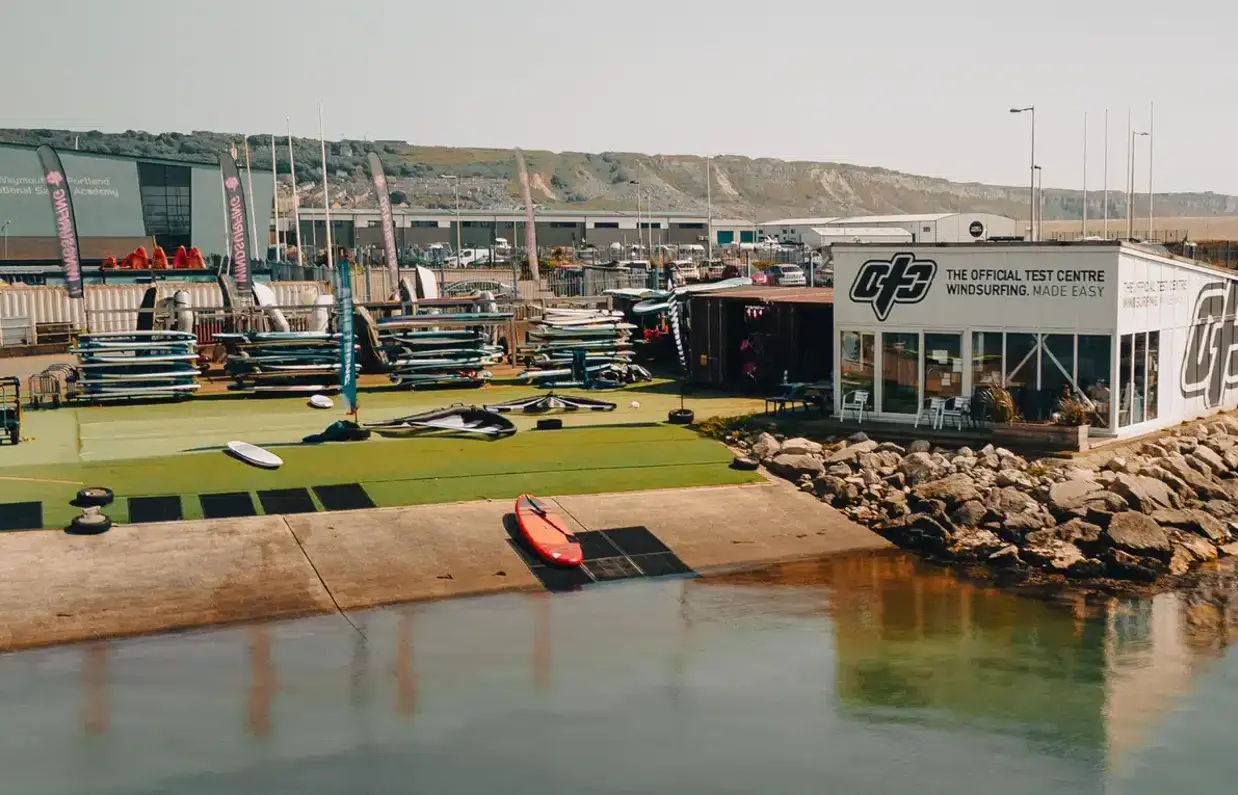 A watersports centre at the water's edge with a range of watersports equipment
