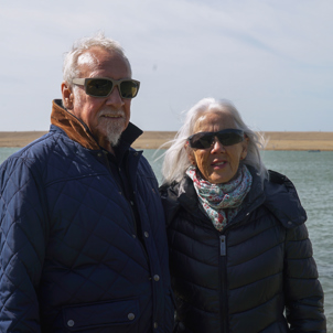 A couple by the sea with Chesil Beach in the background