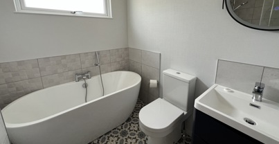 stylish bathroom with tub and floor tiles