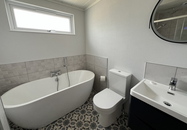 stylish bathroom with tub and floor tiles