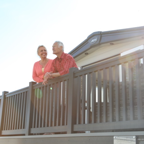 Older couple on decking of caravan