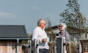 Elder couple relaxing on deck 