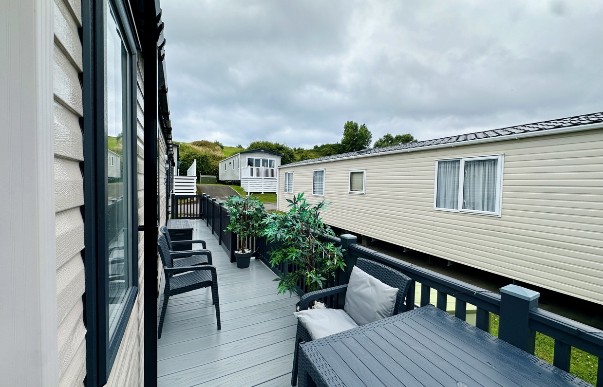 External of a caravan with decking and outdoor furniture