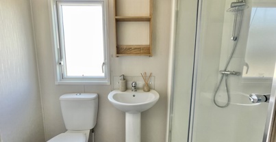 Internal of a caravan bathroom with shower, sink and toilet
