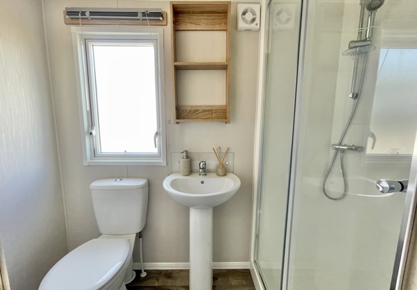Internal of a caravan bathroom with shower, sink and toilet