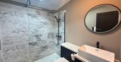 Internal of a lodge bathroom with shower toilet and sink