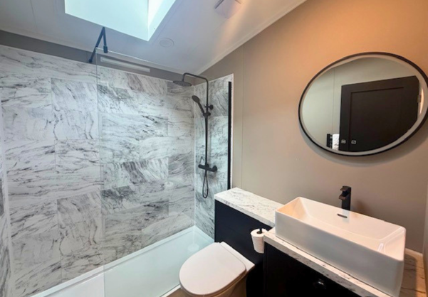 Internal of a lodge bathroom with shower toilet and sink