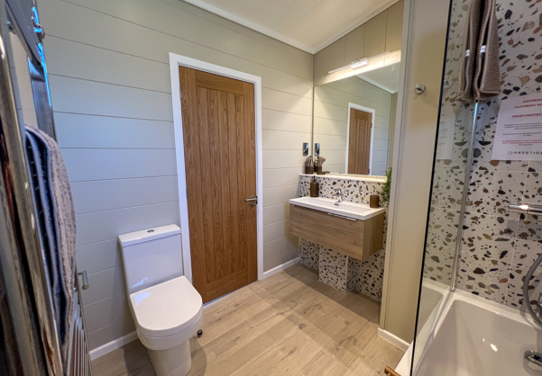 Internal of a luxury lodge bathroom with shower over bath toilet and sink