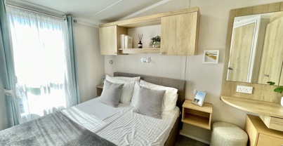 Internal of a caravan master bedroom with dressing area