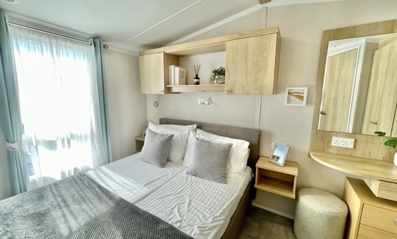 Internal of a caravan master bedroom with dressing area