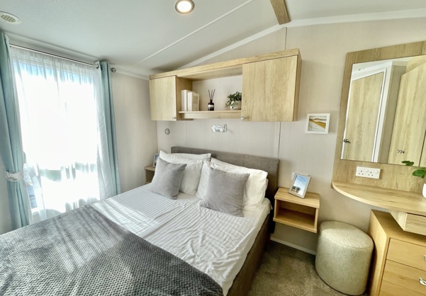 Internal of a caravan master bedroom with dressing area