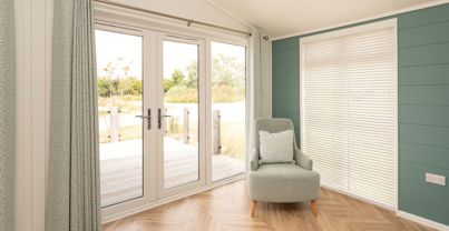 Internal of a luxury lodge open plan living space with french doors out to decking