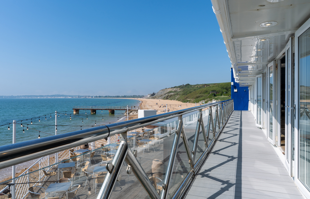 Sea, beach and Weymouth Bay views from Drift Bar & Grill balcony on a sunny, blue sky day