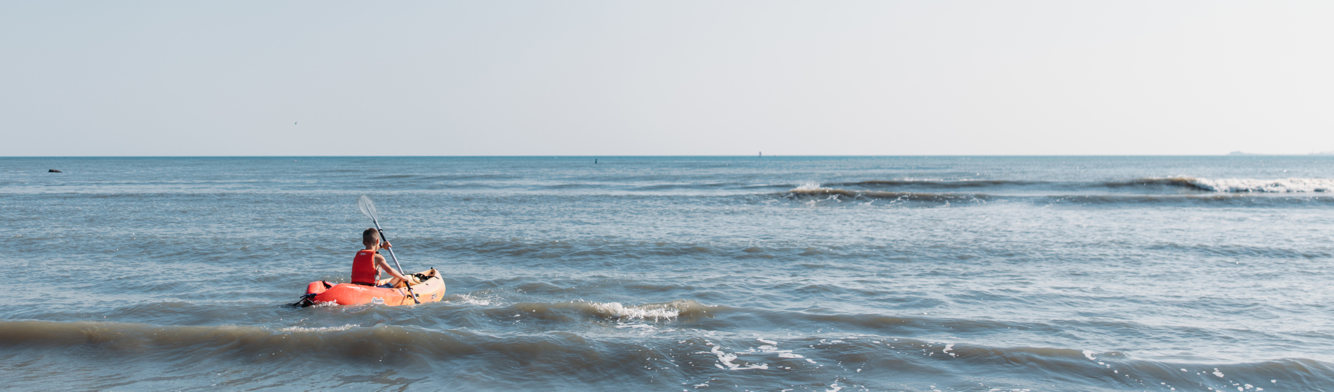 A Child Kayaking in the Sea
