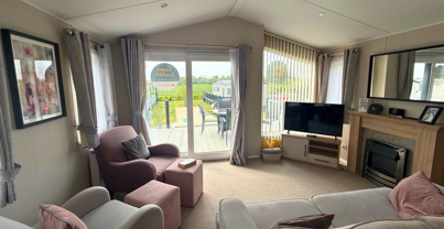 Internal of a caravan lounge looking out to decking