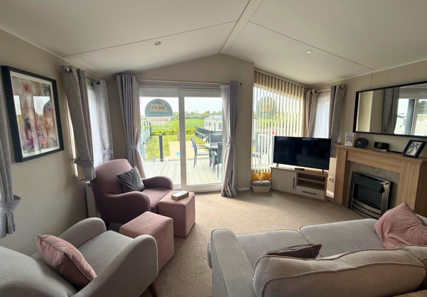 Internal of a caravan lounge looking out to decking
