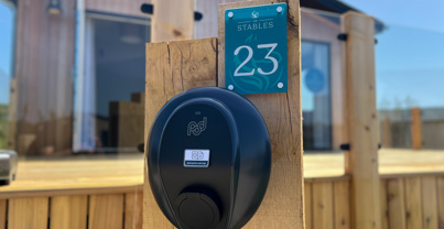 External of a luxury lodge with decking and EV charging point