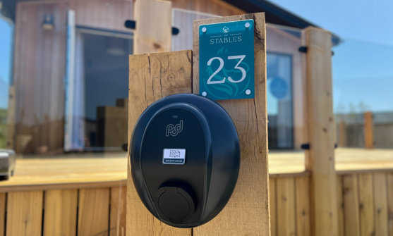 External of a luxury lodge with decking and EV charging point