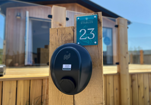 External of a luxury lodge with decking and EV charging point