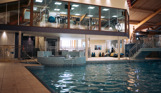 A heated indoor pool with jacuzzi area and gym