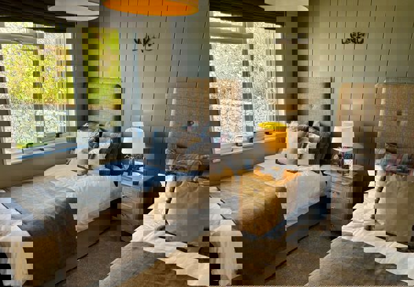 Modern country theme twin bedroom with sage walls and checked bedding