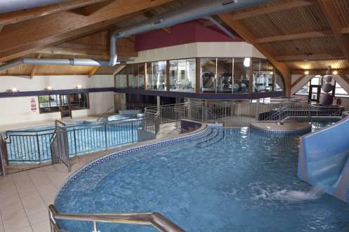 A heated indoor pool leisure complex with multiple areas, slides, jacuzzi and gym