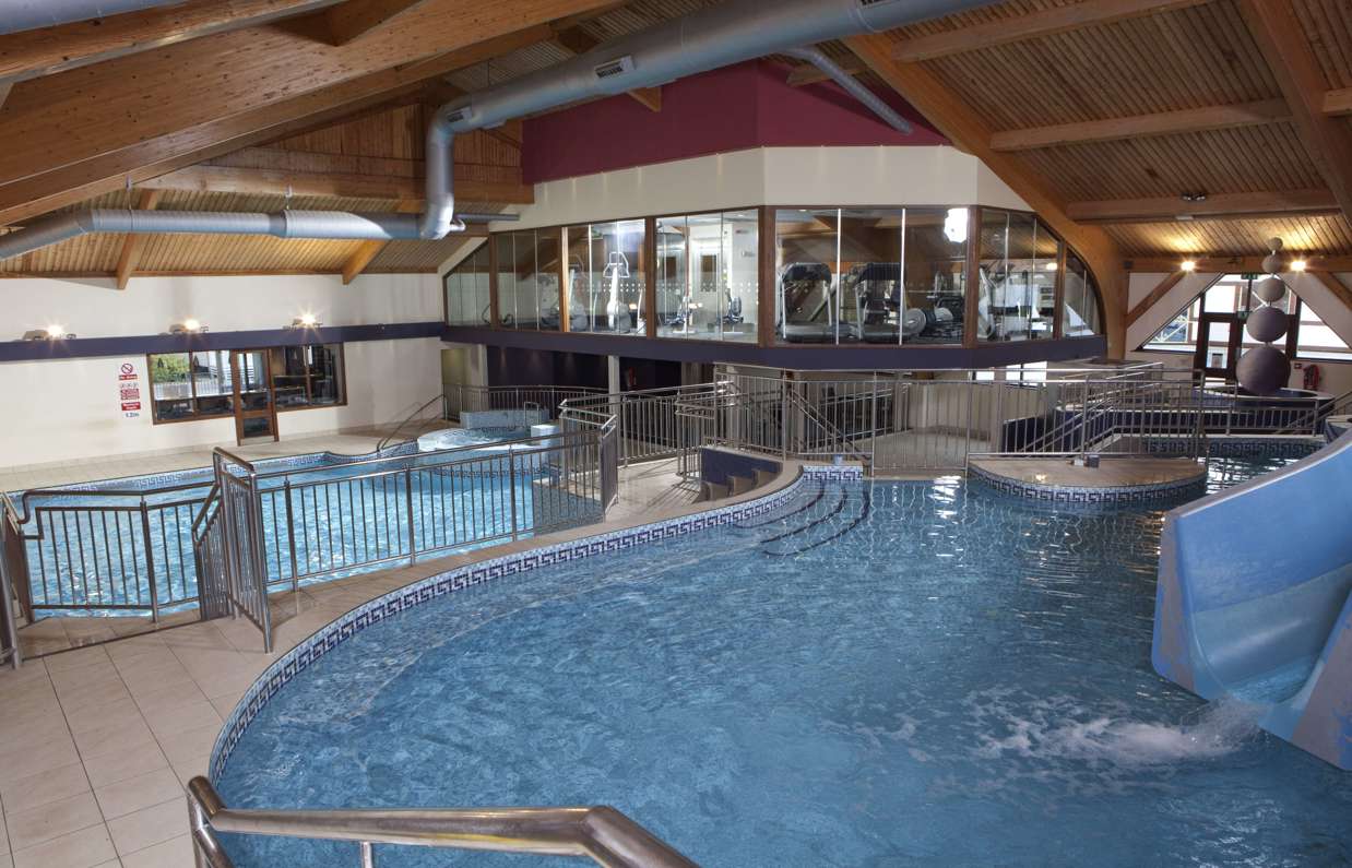 A heated indoor pool leisure complex with multiple areas, slides, jacuzzi and gym