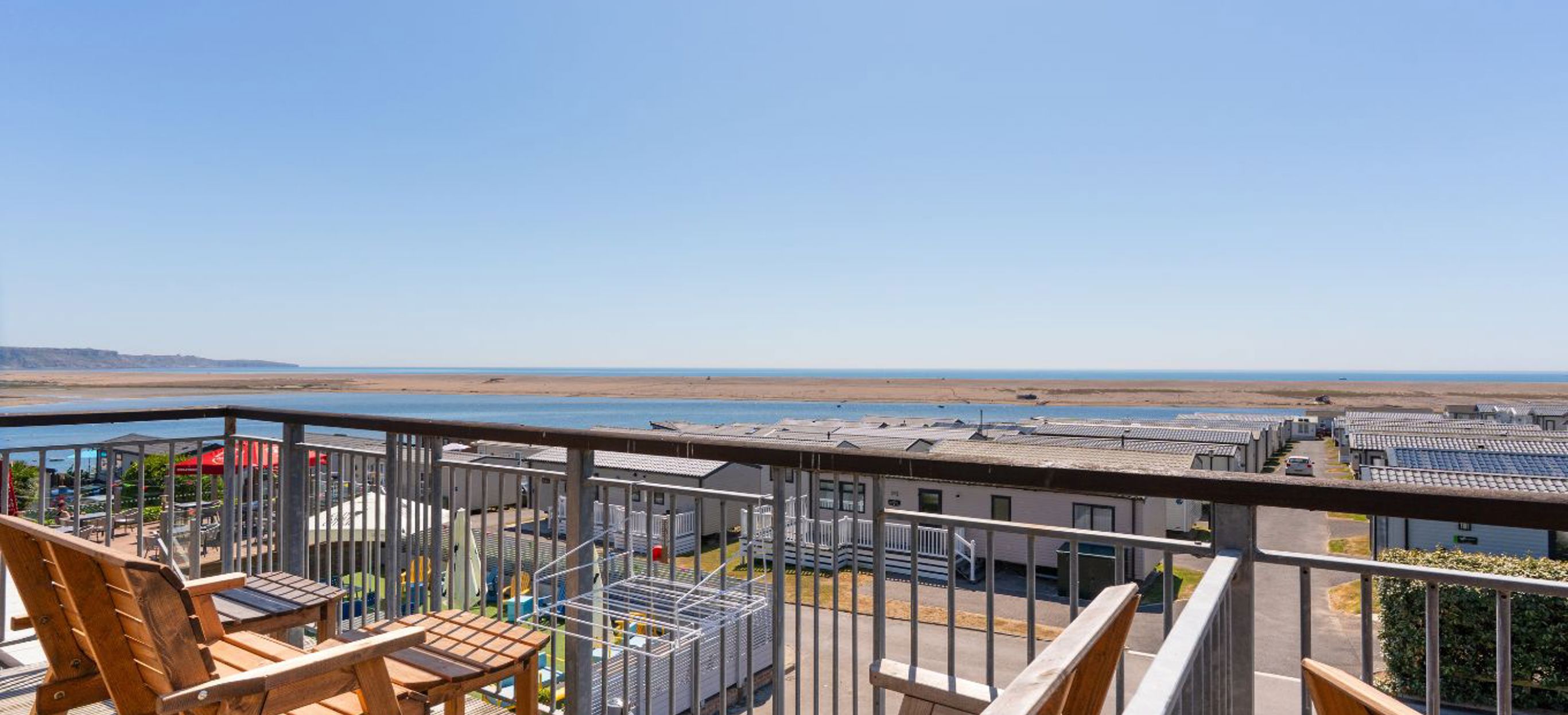 Views of Chesil Beach and the Jurassic Coast from the balcony of Chesil Beach apartments with outdoor furniture