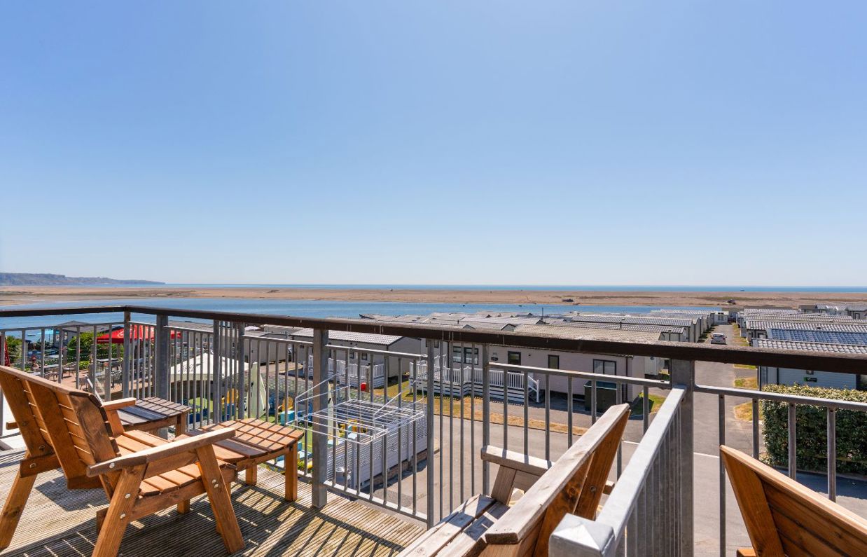 Views of Chesil Beach and the Jurassic Coast from the balcony of Chesil Beach apartments with outdoor furniture