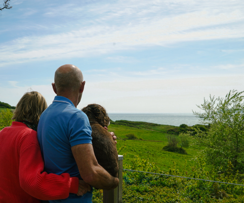 Osmington Owners enjoying view from deck with dog