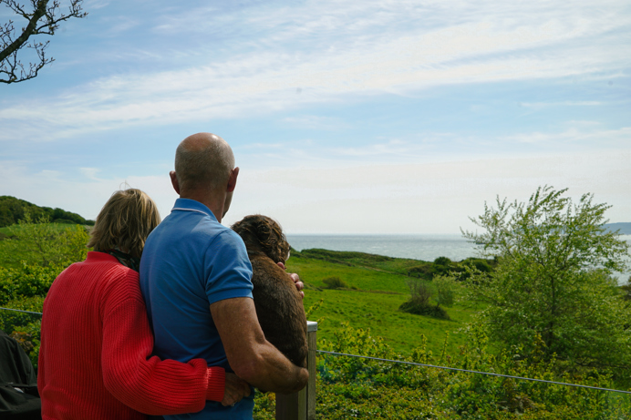 Osmington Owners enjoying view from deck with dog