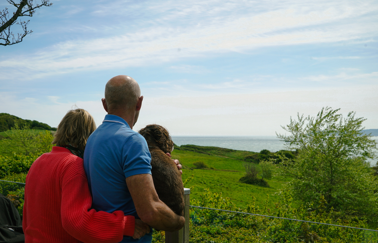 Osmington Owners enjoying view from deck with dog