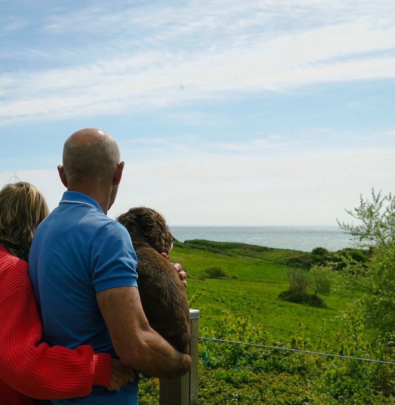 Osmington Owners enjoying view from deck with dog