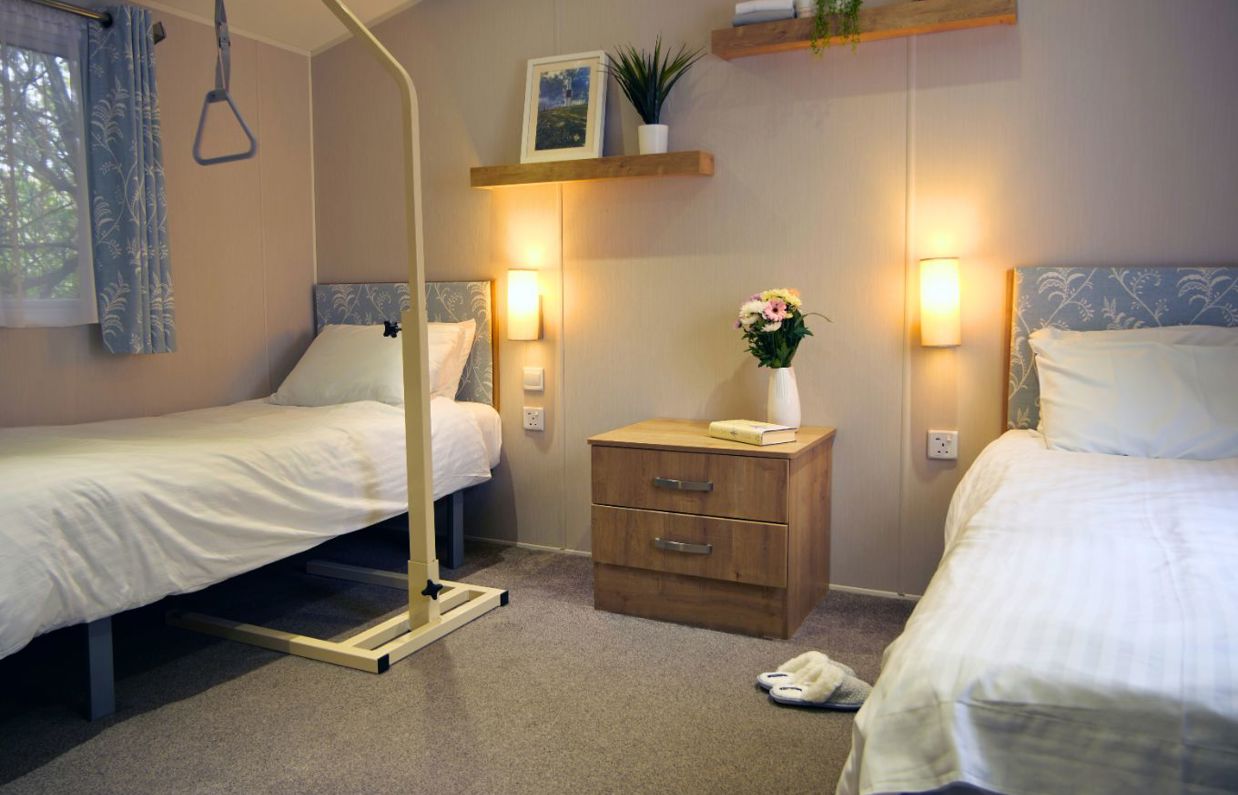 Internal of an accessible caravan spacious twin bedroom with hoist