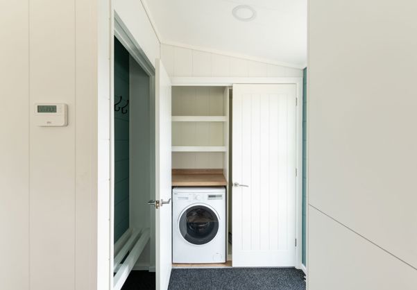 Internal of a luxury lodge hallways with washing machine
