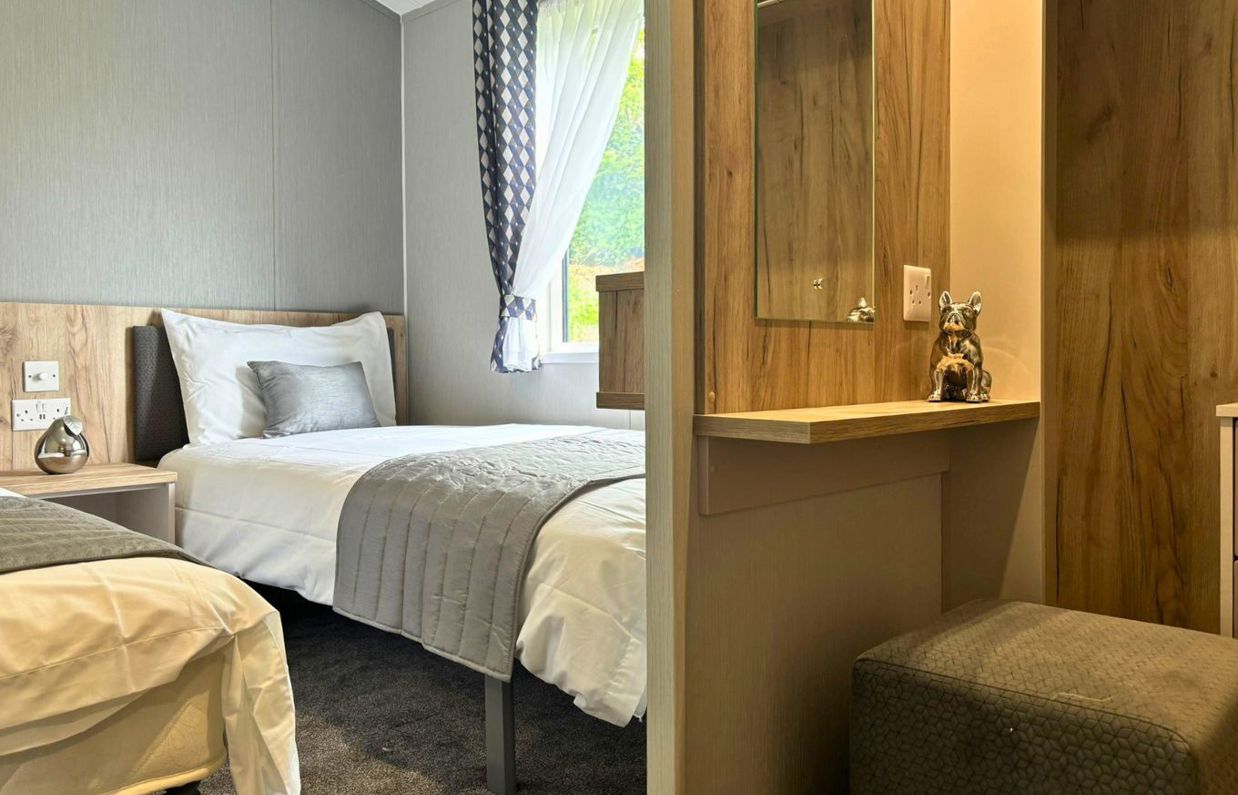 Internal of a lodge twin bedroom with dressing area