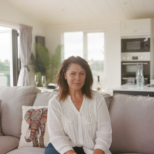 A woman sat on the sofa in a holiday home