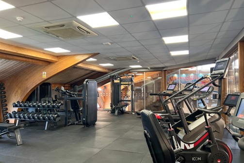 Inside of a modern gym facility with various equipment