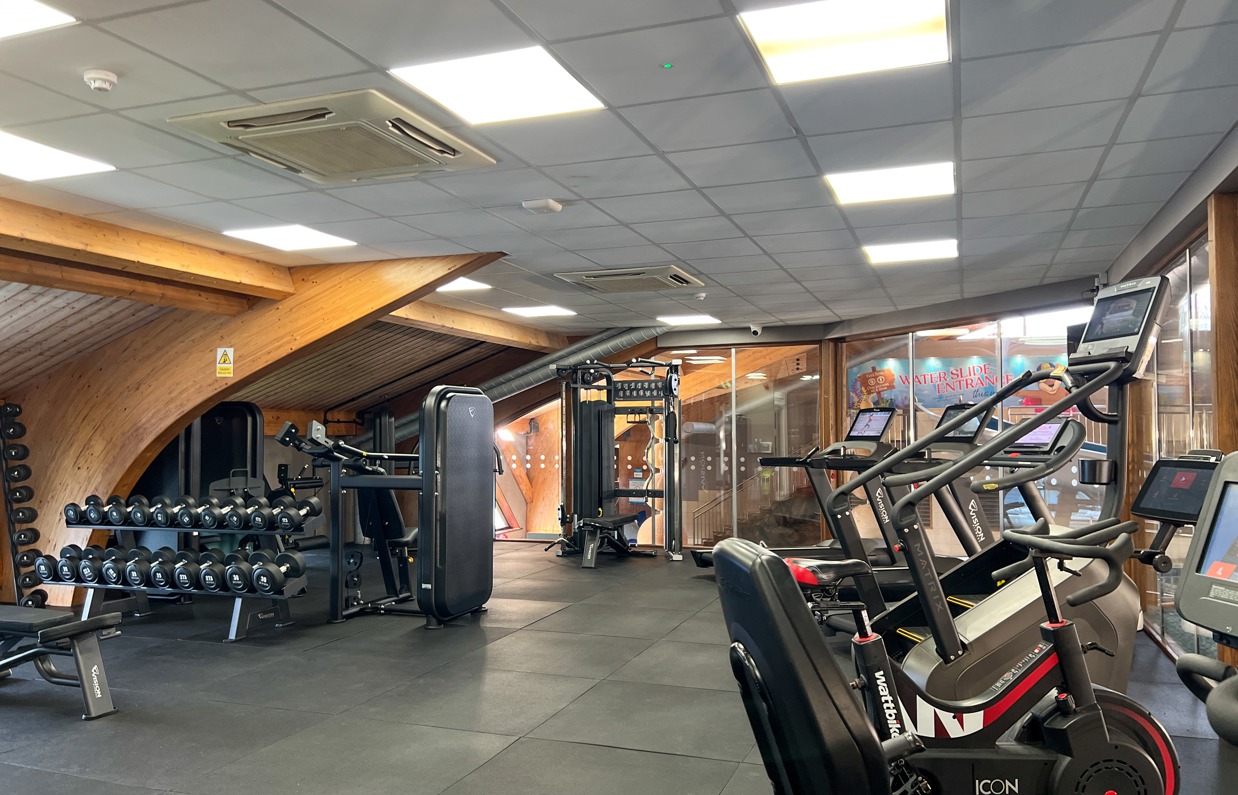 Inside of a modern gym facility with various equipment
