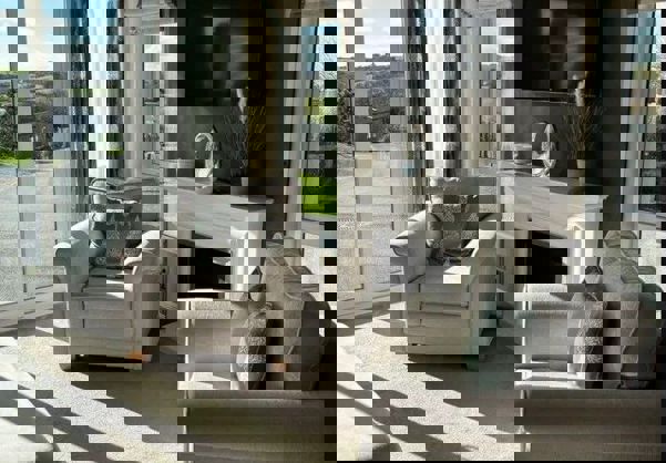 Armchairs in lounge on either side of fireplace