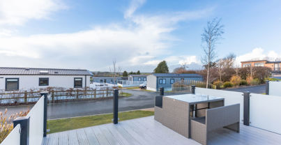External of a caravan decking with table and benches