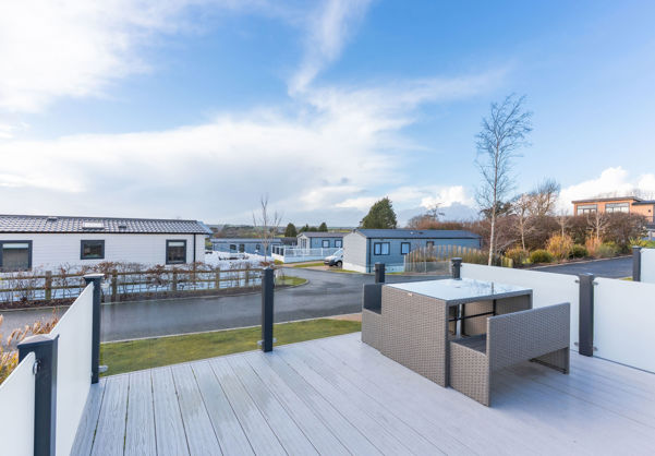 External of a caravan decking with table and benches