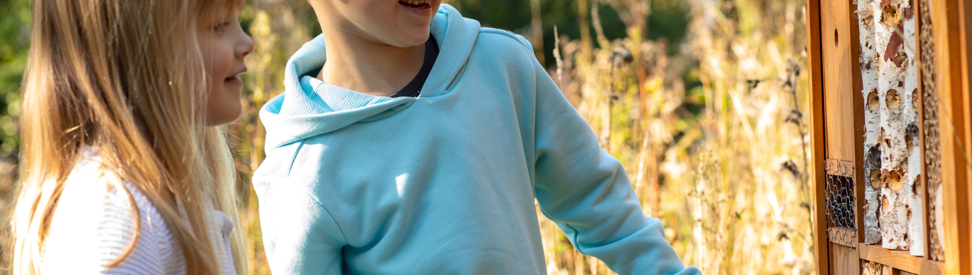 A young boy and girl smiling looking at nature